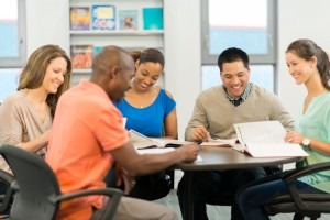 A diverse group of managers studying employment law together.