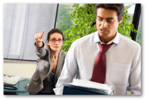 Aggressive woman pointing and calling to man.