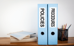 Binders labeled policies and procedures. 